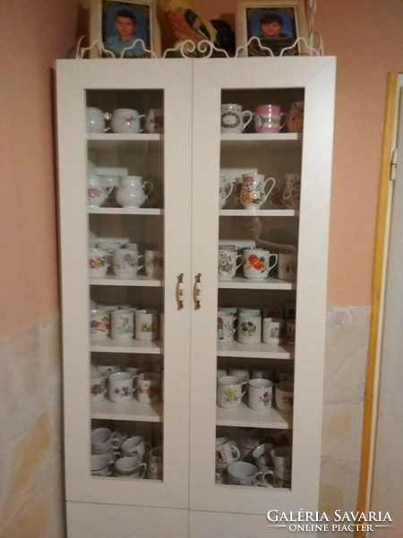 Modern display cabinet in empty condition with porcelain copper handles