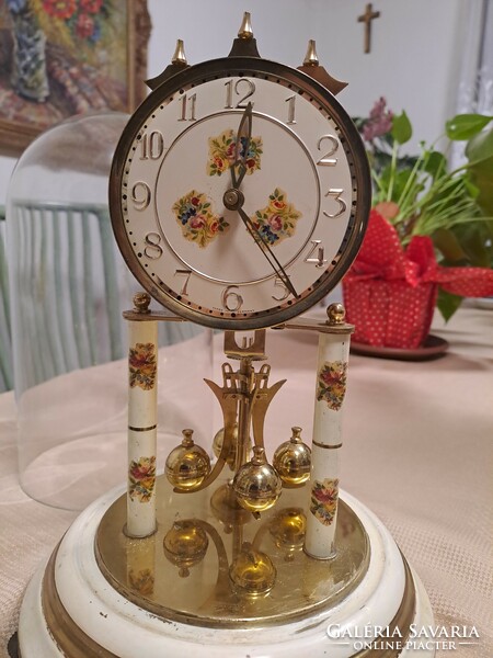 A beautiful table clock with a rotating pendulum