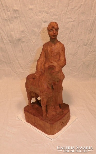 Carved statue of a man with a goat. Indicated.