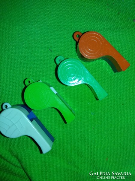 Old traffic goods bazaar colored plastic whistles according to the pictures