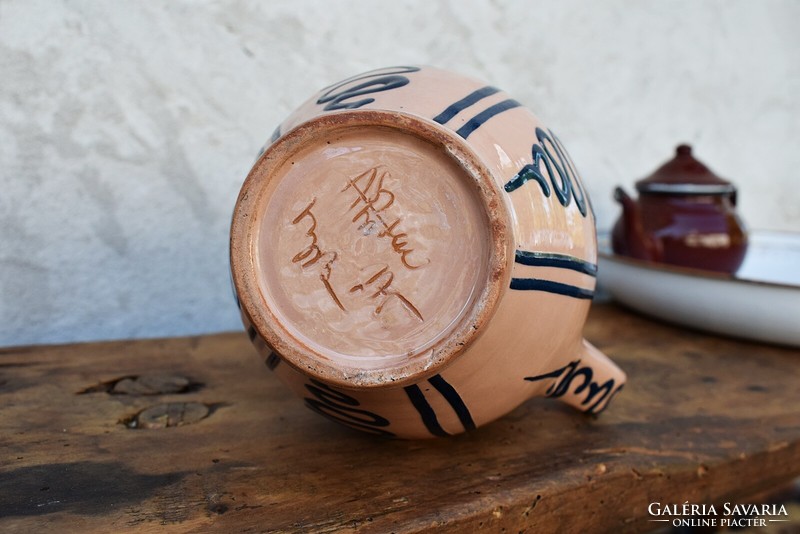 A folk marked glazed ceramic mug