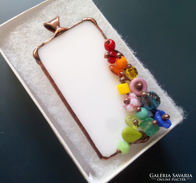 Richly visual glass pendant on white glass with colorful beads