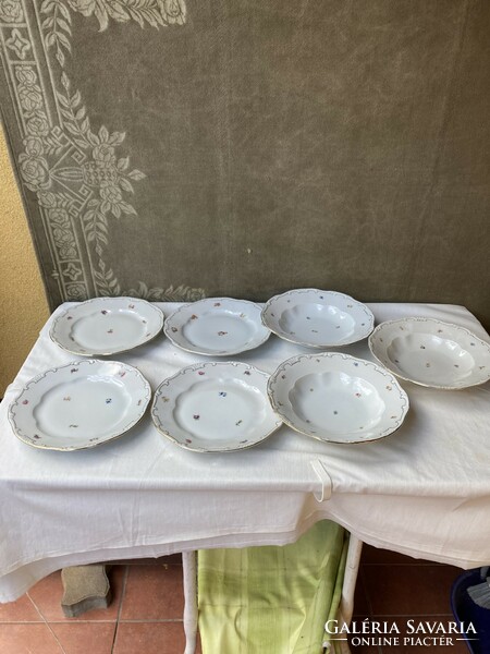 4 flat 3 deep Zsolnay porcelain plates with small flowers.