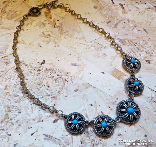 Old metal necklace decorated with blue stones