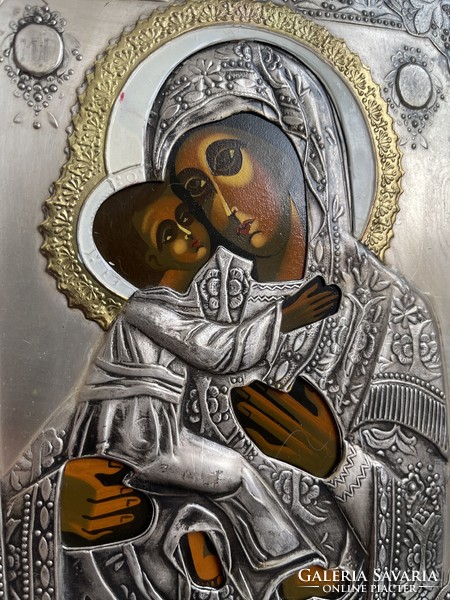 A wonderful hand-painted icon with a metal plaque with a raised gloria.