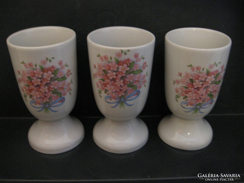 Pink forget-me-not ceramic glasses and vases with a bouquet
