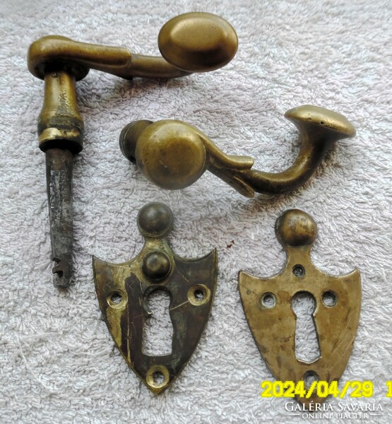 Pair of antique doorknobs with a shield-shaped lock coat of arms