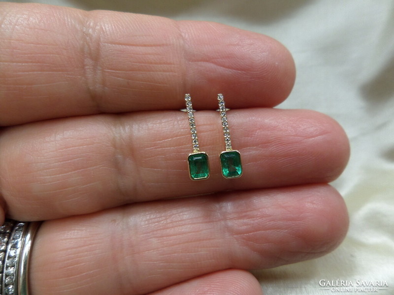Gold stud earrings with a pair of emeralds and snow-white tiny glasses