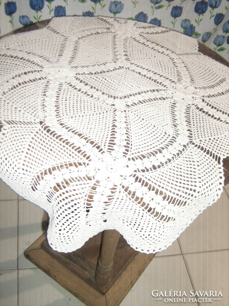 Beautiful white hand-crocheted tablecloth with a special shape of flowers