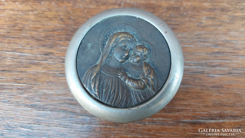 An old, religious round box with a baby Mary