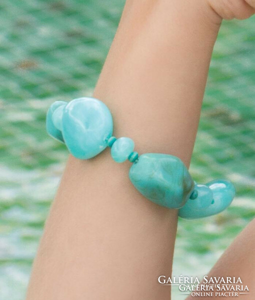 Bracelet made of quality turquoise colored acrylic beads with small wooden beads