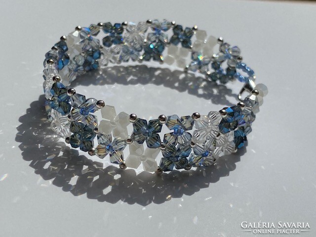 Elegant laced bracelet made of multicolored Austrian polished crystal glass beads.