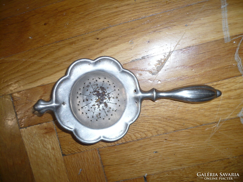 Antique metal tea strainer