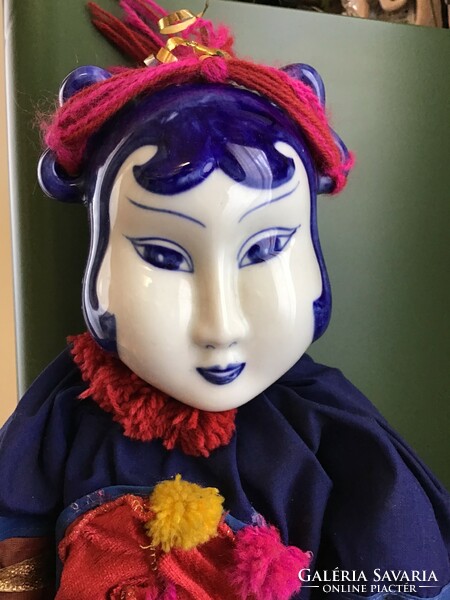 Large porcelain head doll with porcelain hand and foot ends in handmade clothing
