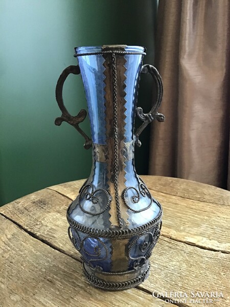 Glass vase decorated with old handmade copper