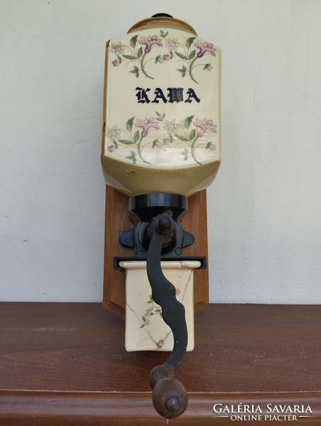 A wall-mounted coffee grinder with a nice solid decor and a ceramic body