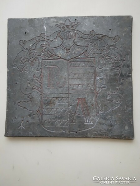 Lead sheet, engraved with a figure of a coat of arms.
