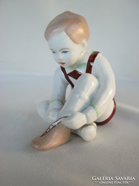Little boy pulling Aquincum porcelain shoes