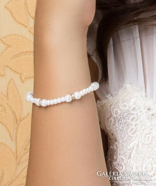 White glass bead bracelet with golden, crystalline metal rings