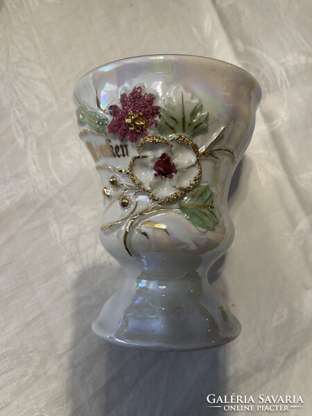 Very beautiful antique porcelain cup with luster glaze and embossed flowers.